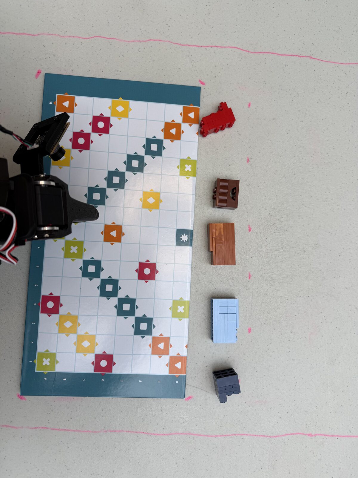 The five colored gift blocks lined up beside the board